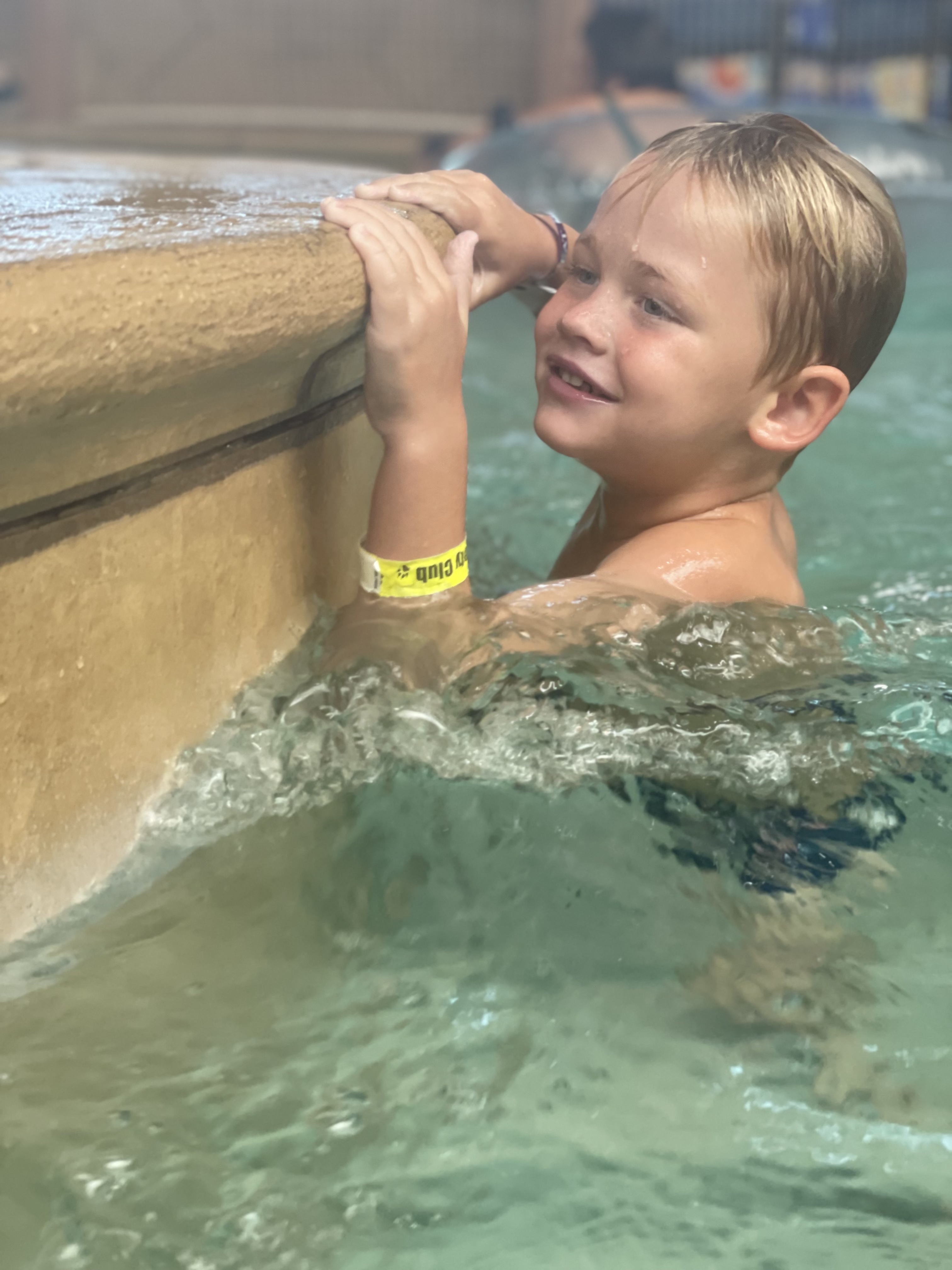Happy child learning to swim